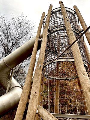 Kids climb up the various rope levels to get to the slide.