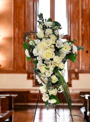 If you're interested in the all white sympathy cross from Twigs and Blooms florist.