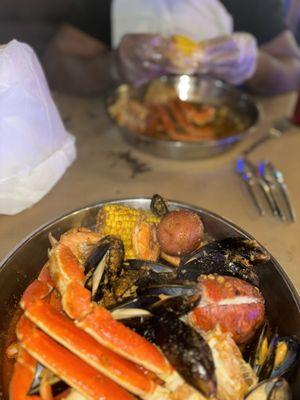 A whole pound of clusters, muscles, headless, shrimp, corn, lobster, and potatoes