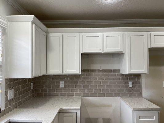 Cabinets were previously brown wood. We sanded and repainted them a beautiful white color creating an new environment for many family meals!