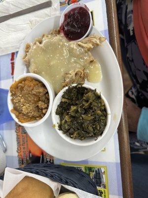 Chicken and dressings with turnip greens and sweet potato casserole. Side of cranberries.