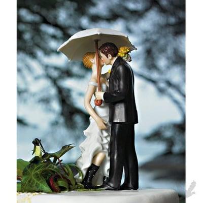 A beautiful dress, a stylish suit, one white umbrella and a great pair of rubber boots all combine to create this cake topper!