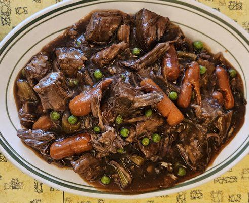 Beef Pot Roast with peas, carrots, and mashed potatoes underneath!