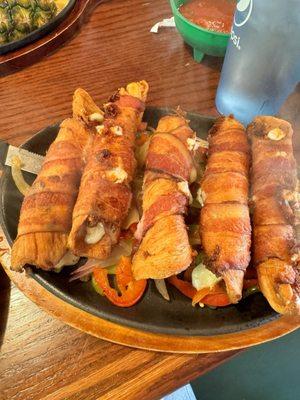 Chicken al Diablo. Bacon wrapped chicken on a bed of peppers. Stuffed with cheese. Wow
