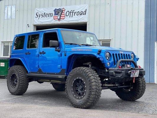2016 Jeep JKU Hardrock w/ 37 tires, Metalcloak 4" lift & Overline (front) & Overland (rear) series fenders, and Rockslide Engineering steps.