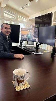 Marcus Lund CPA sitting in a desk. Smiling at camera.
