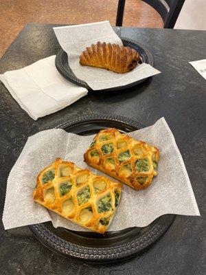 Two spinach and feta pastries and a chocolate croissant.