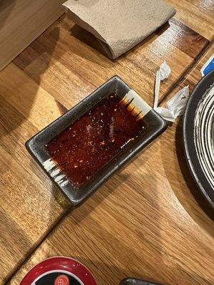 Sauce platter of chili oil that costs an extra $1.00