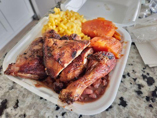 Jerk chicken dark with rice and peas, macaroni and cheese, and yams