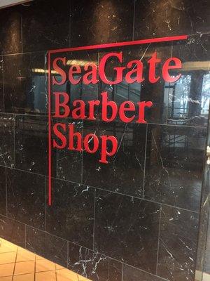 SeaGate Barber Shop. Located in the lower level and connected to the Renaissance a hotel next door. Great haircut!