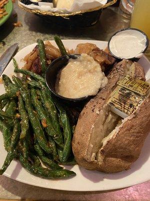 Two medallions with onion and garlic purée with teriyaki green beans and baked potato