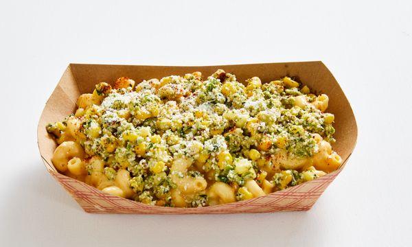 Elote Mac! OG Mac topped with roasted corn, jalapeño, cilantro, vegan mayo, cotija, & chili pepper-paprika sprinkle.