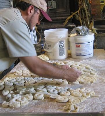 Making hot, fresh donuts.