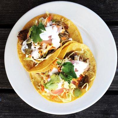 HAPPY HOUR!  Two house-made carnitas street tacos for $6.  They have a kick!