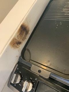 Burn marks next to range in kitchen.