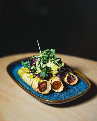 Food menu at the bar. Taquitos de Papa || potatoes, salsa, pickled cabbage.
