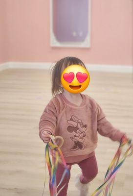 My daughter playing with ribbons provided by staff
