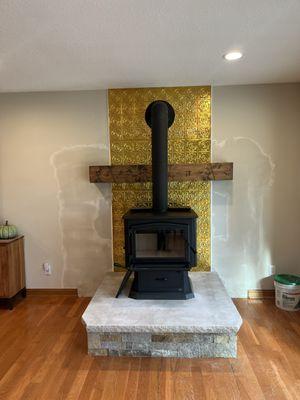 Free standing wood stove installed on Indiana Limestone hearth.