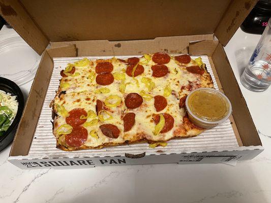 Sad pizza with the embedded salad dressing.