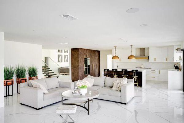 Stylish living room at the los angeles drug rehab, showcasing modern decor, a sleek staircase, and high ceilings...