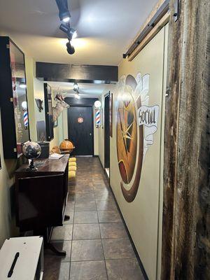 The upstairs hall. Barbershop at the end where the pole is
