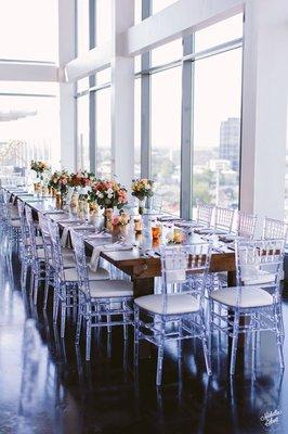 Estate table with crystal ice chiavari chairs with ivory cushions