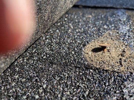 Nail pushed through the shingle, causing a leak