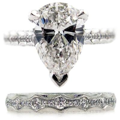 Pear shaped diamond engagement ring and wedding band, set in platinum.