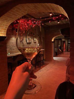 My glass of Sauvignon blanc with the interior of La Cave!