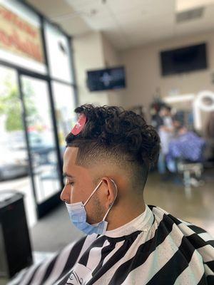 Curly hairstyle shave fade with lineup.