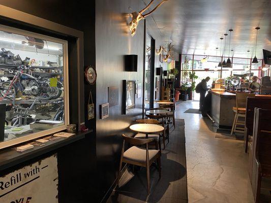 Inside seating with a view of the mechanic shop next door.