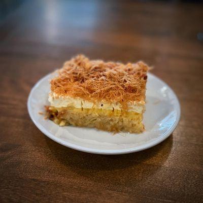lemon cake topped with pastry cream, nuts and kataifi.