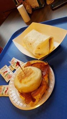 Breakfast burrito and the English muffin breakfast sandwich with ham and bacon.