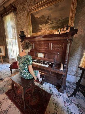 An organ with foot pedals that blow air through paper rolls with holes in them.