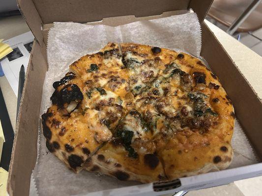 Sausage, spinach, cheese and vodka sauce pizza. Absolutely delicious. Note the charred bubbles.