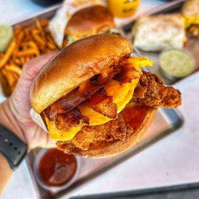 Signature Egg N Bird Sandwich! Choice of Grilled or Fried Chicken, Egg, Bacon, Cheese, Spicy Honey and Crack Sauce on a Toasted Brioche Bun