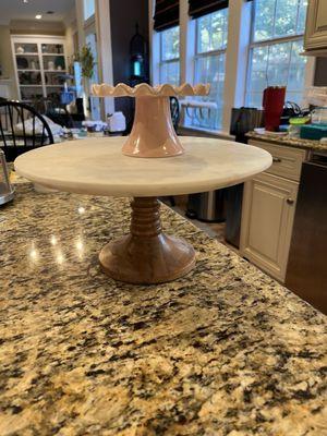 Nested fig cake plate sitting on a normal sized cake plate for scale.