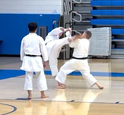 JKA of SF Bay Chief Instructor T.J. Stiles, kicking at left, during a rank examination.