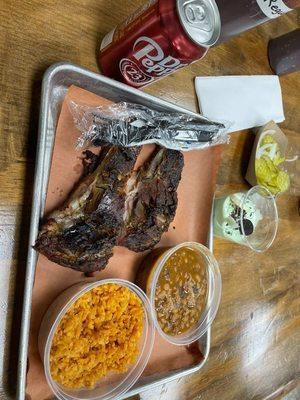 Pork ribs, rice, beans, dr. Pepper, and complementary pudding.