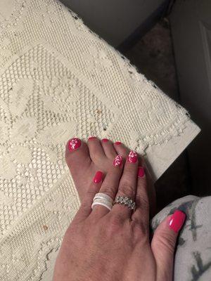 Hand on top of foot showing full set/pedicure