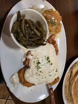 Country fried chicken with mashed potatoes and green beans.
