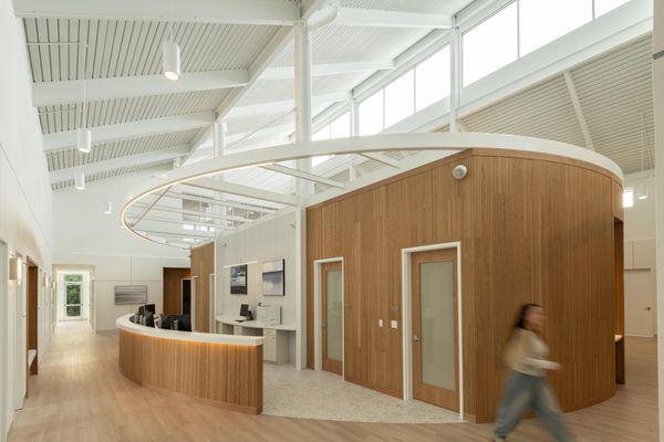 Refined materials, natural light, and architectural warmth elevate institutional design. Kimmel Interiors.