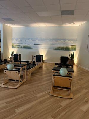 Reformers with Coastal Muralat Sweetgrass Pilates
