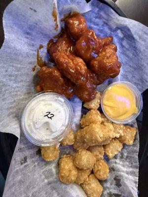 Boneless wings with mild BBQ sauce. Tater tots with nacho cheese dip and a side of ranch for the wings.