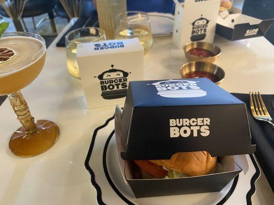 My complete meal - a burger in the foreground, and a box of fries in the background.