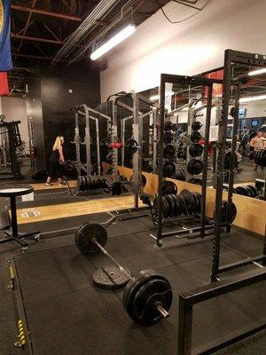 Multiple racks and even more bars. Olympic bumper plates and standard handle plates to accommodate all styles of lifting. Chalk as well.