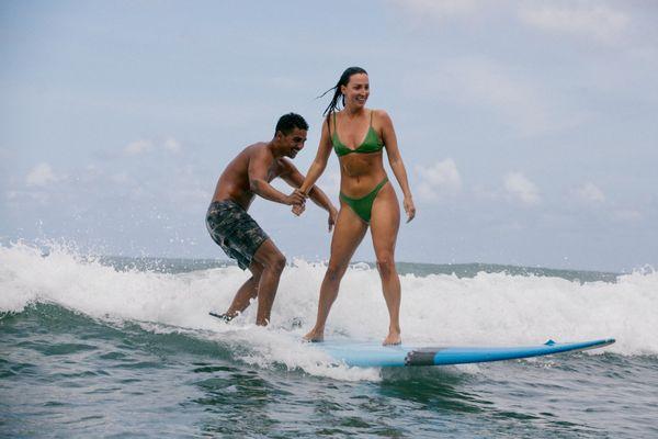 Kekai and K sharing a surfboard together