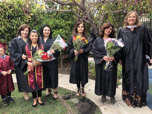 On graduation day, the teachers don their own graduation gowns.