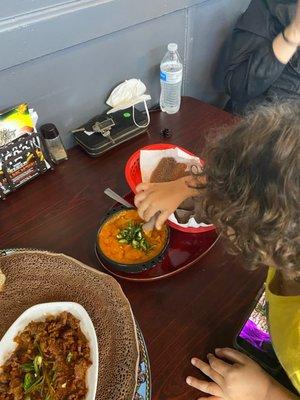 Yummy food (tibs and lentils) with injeera