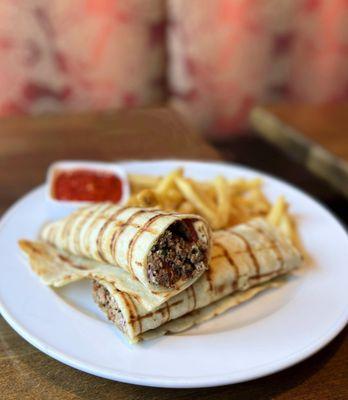 Spicy Adana Wrap: Spicy Ground Lamb + Beef, haydari, pickles, red onion, parsley, homemade tomato salsa, fries | $15